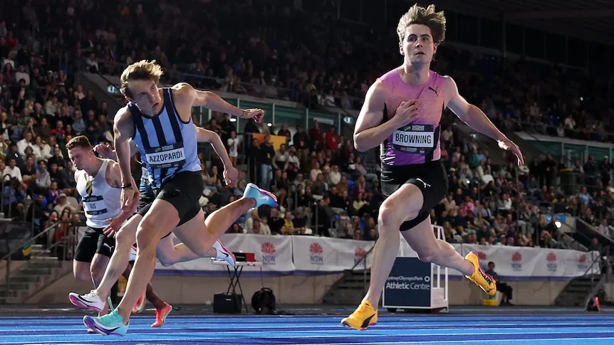 Josh Azzopardi and Rohan Browning cross the finish line in the 100m final at the Australian National Athletics Championships.